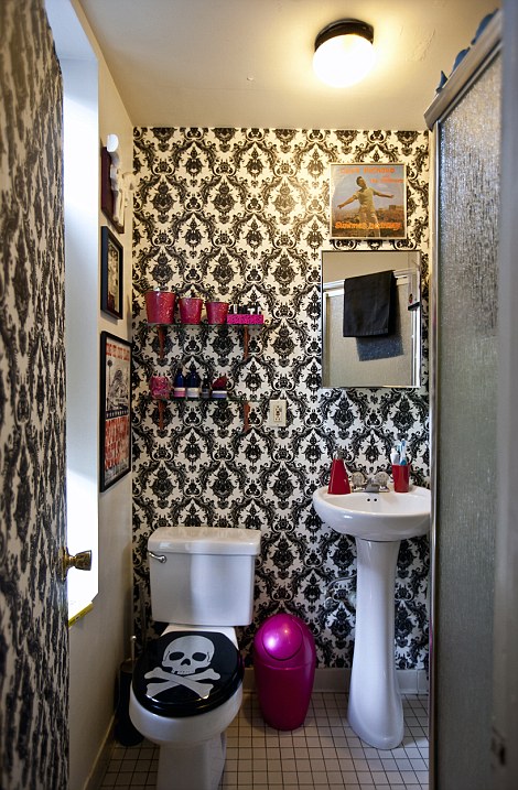 'We had to work within strong limitations which is why color and pattern were essential into creating distinctive areas,' explains Jeanie. Pictured, the tiny lavatory