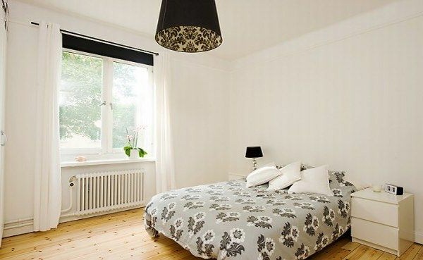 Designed bedrooms in a Scandinavian style bed next to the window white walls