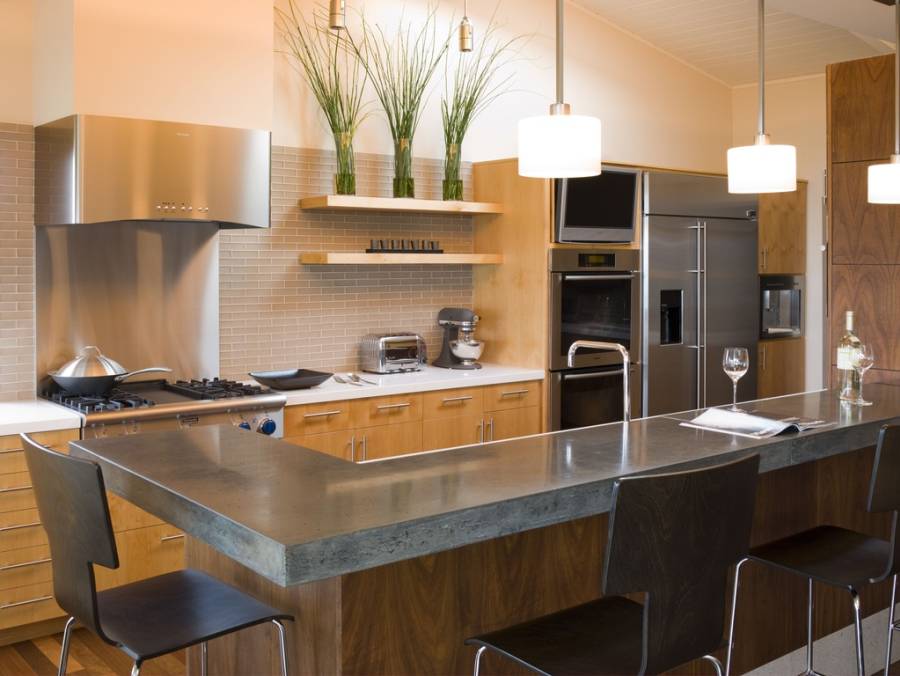 Designer custom kitchen with concrete counter island with dining nook