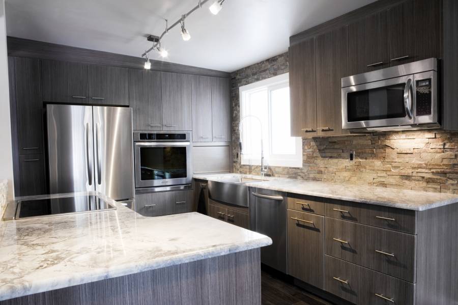 Contemporary kitchen with dark wood cabinets and white marble counters