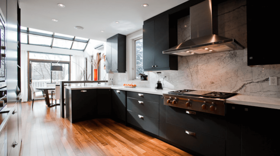 Contemporary kitchen with dark wood cabinets and white marble counters