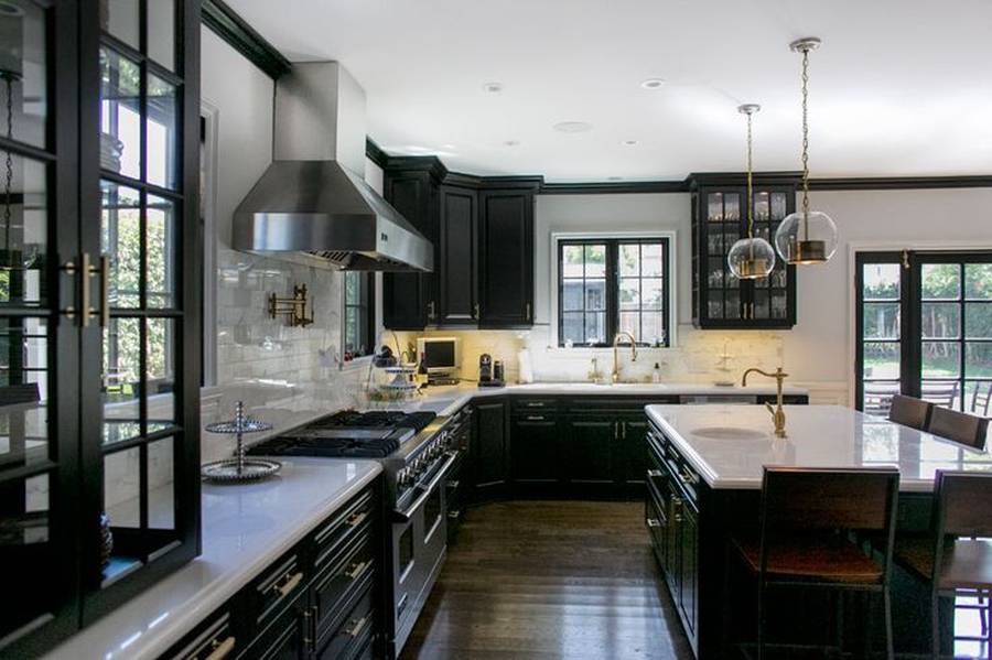 Contemporary kitchen with dark wood cabinets and white marble counters