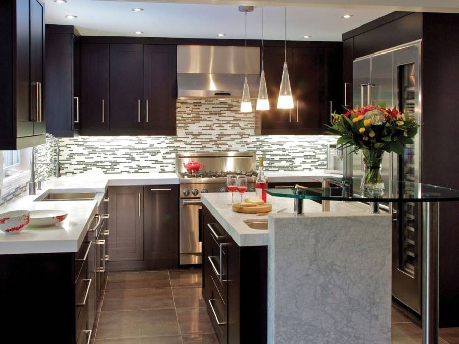 Contemporary kitchen with dark wood cabinets and white marble counters