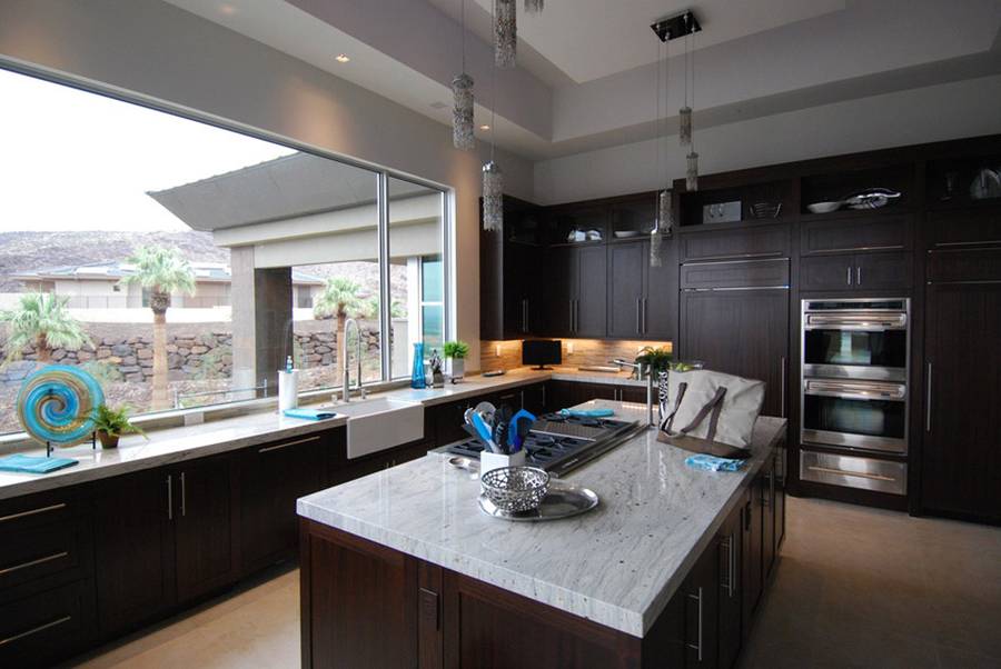 Contemporary kitchen with dark wood cabinets and white marble counters