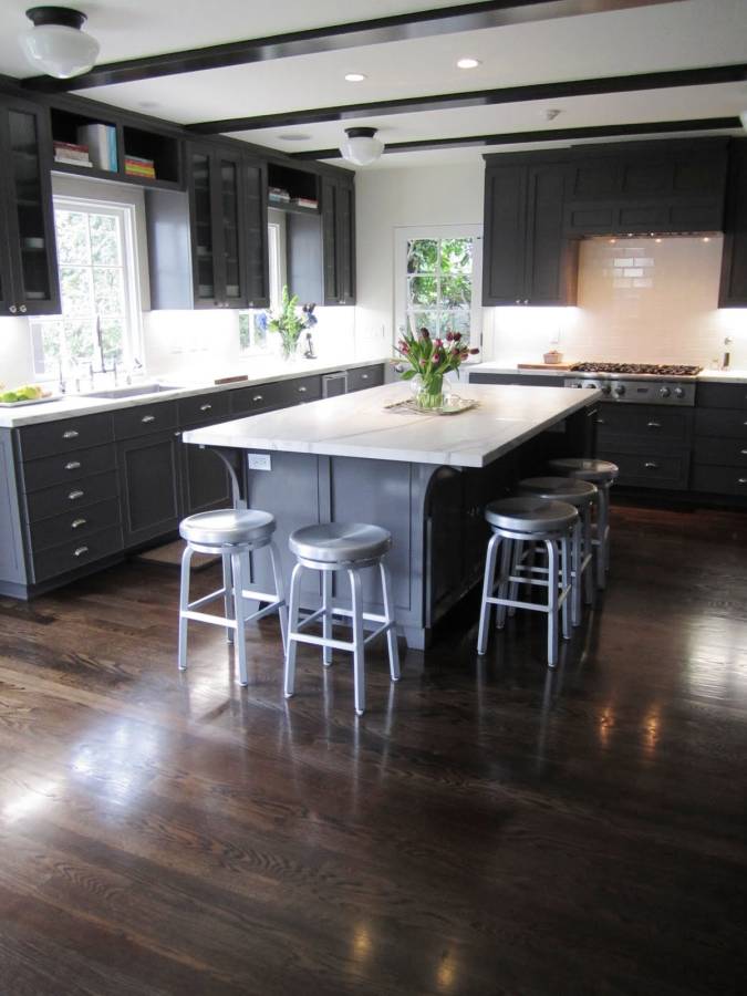 Contemporary kitchen with dark wood cabinets and white marble counters