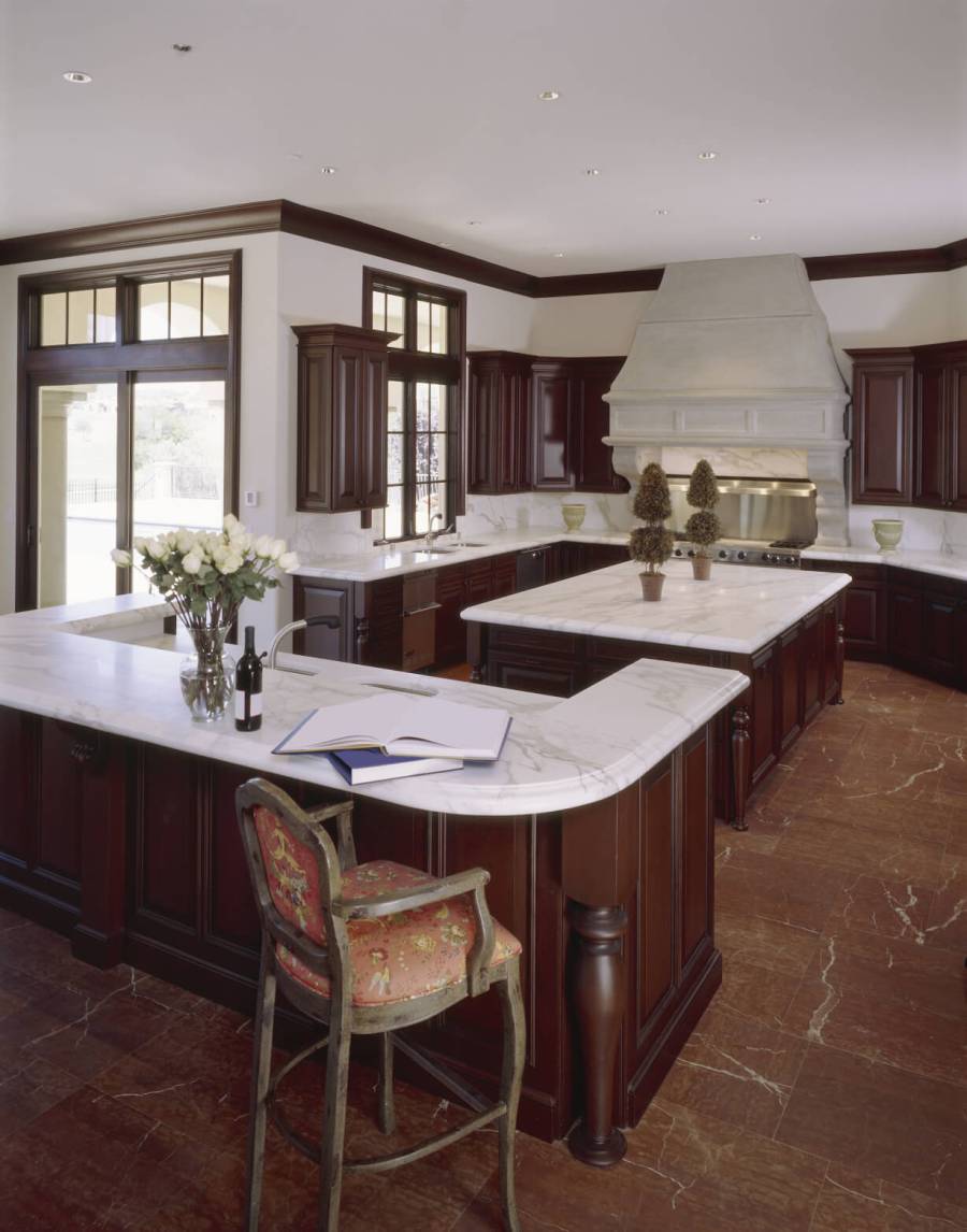 Contemporary kitchen with dark wood cabinets and white marble counters