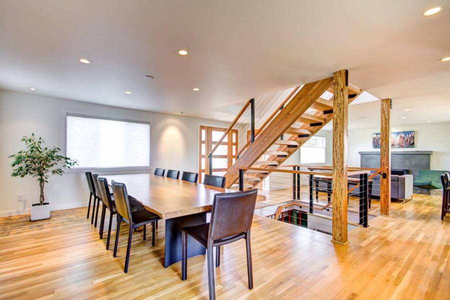 Contemporary kitchen with hardwood floors open to dining room