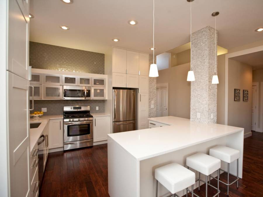 Contemporary kitchen with hardwood floors open to dining room