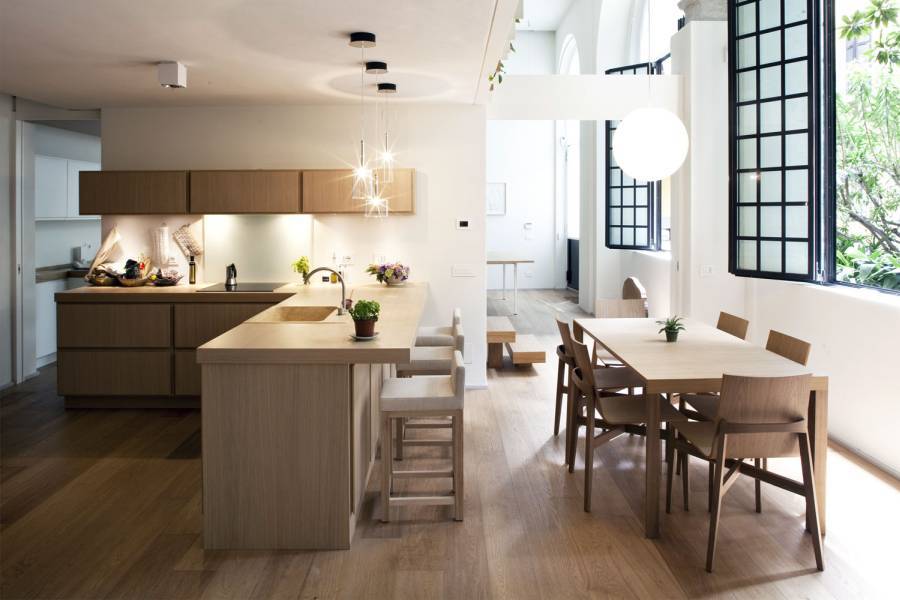 Contemporary kitchen with hardwood floors open to dining room