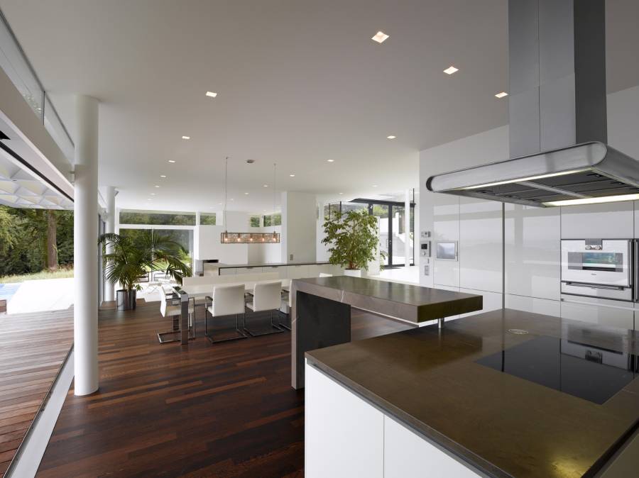 Contemporary kitchen with hardwood floors open to dining room