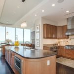 Contemporary kitchen with hardwood floors open to dining room