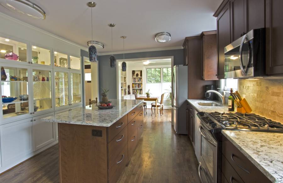 Contemporary kitchen with hardwood floors open to dining room