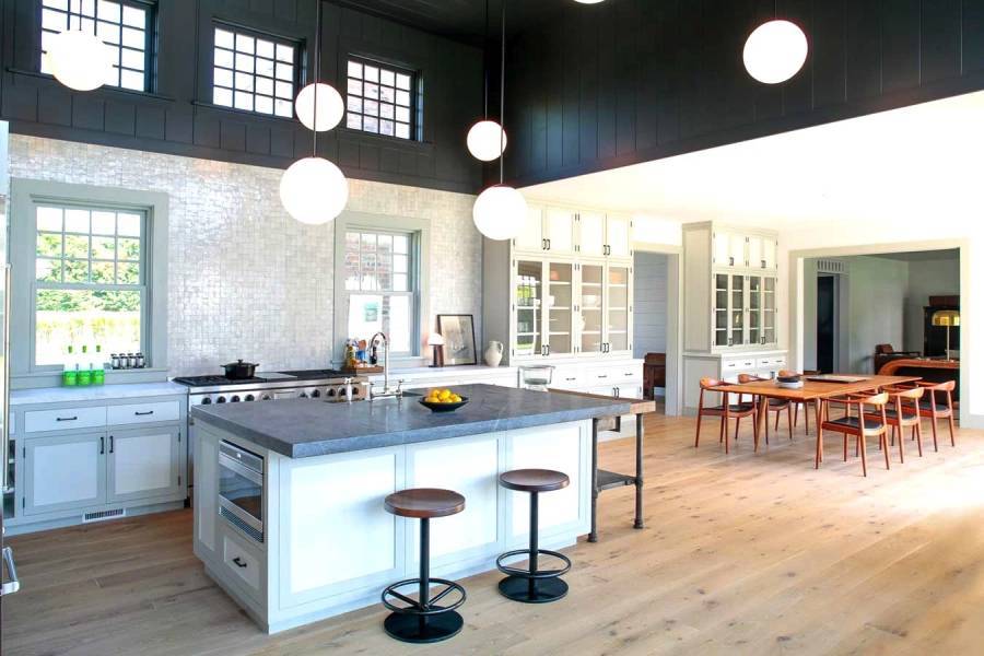 Contemporary kitchen with hardwood floors open to dining room