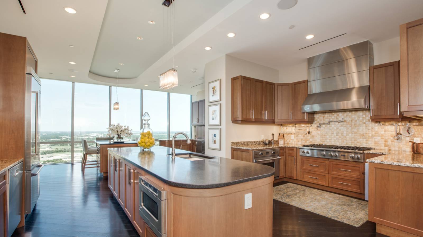 Contemporary kitchen with hardwood floors open to dining room