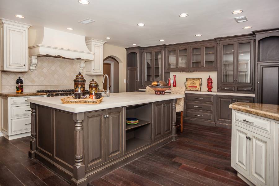 Contemporary kitchen with high ceilings light wood floors and dark cabinets