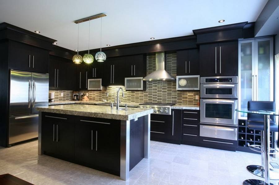 Contemporary kitchen with high ceilings light wood floors and dark cabinets