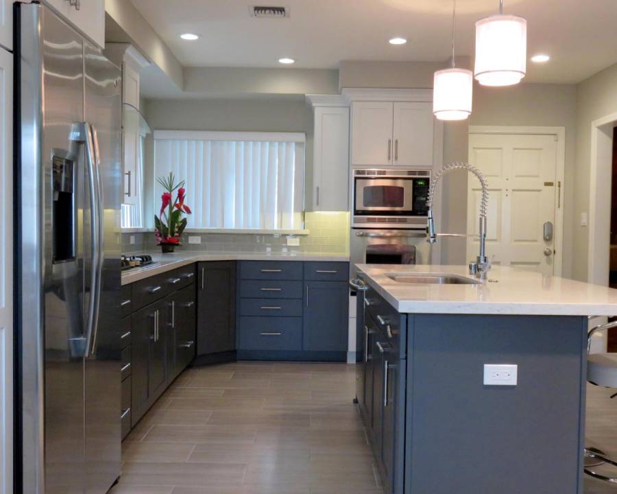 Contemporary kitchen with high ceilings light wood floors and dark cabinets