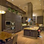 Contemporary kitchen with high ceilings light wood floors and dark cabinets