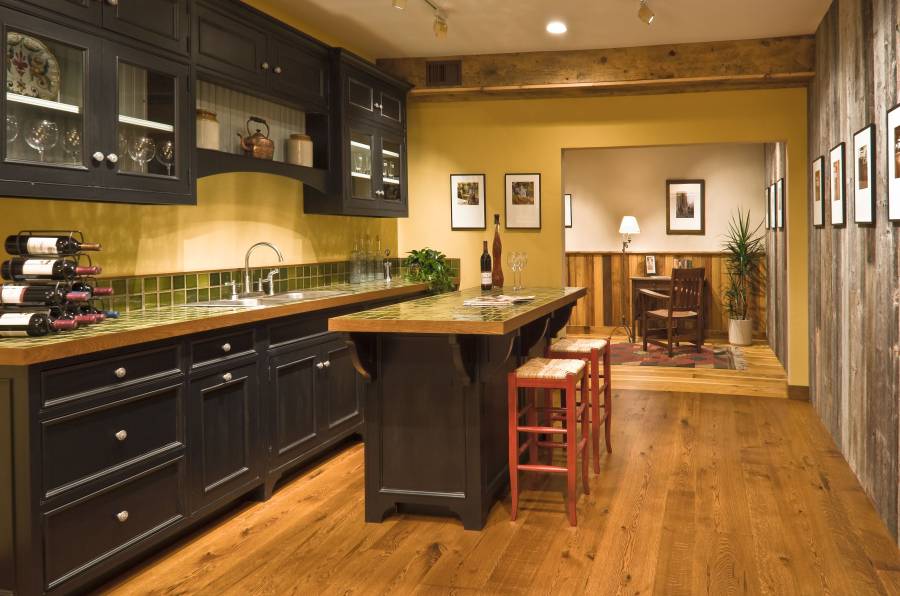 Contemporary kitchen with high ceilings light wood floors and dark cabinets