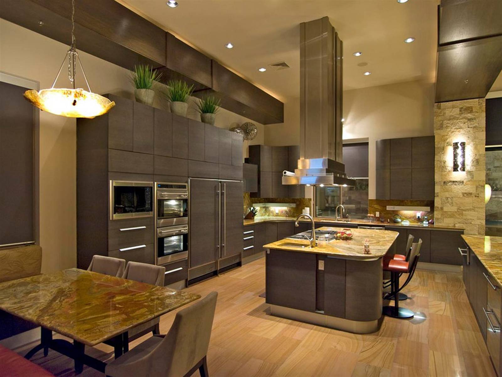 Contemporary kitchen with high ceilings light wood floors and dark cabinets