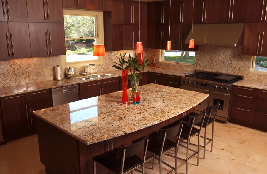 Contemporary kitchen with light granite counters dark wood island