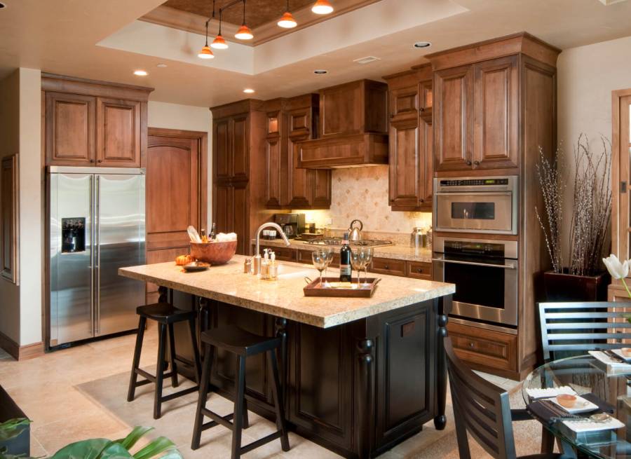 Contemporary kitchen with light granite counters dark wood island