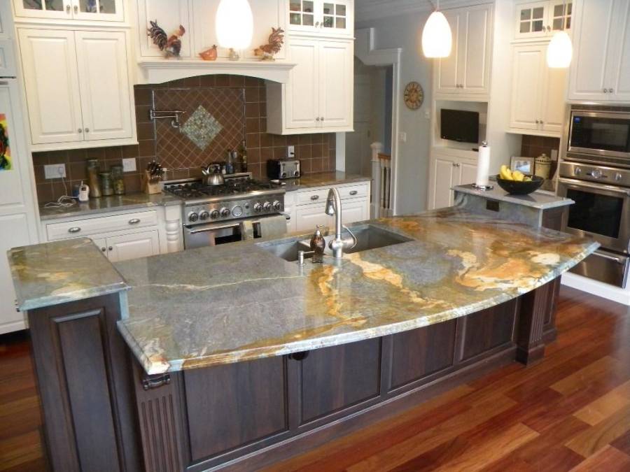 Contemporary kitchen with light granite counters dark wood island