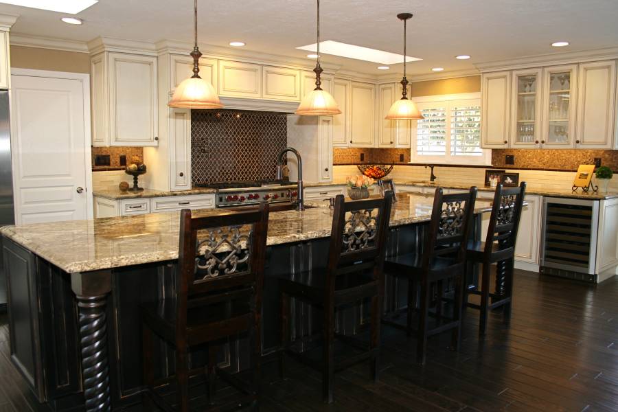 Contemporary kitchen with light granite counters dark wood island