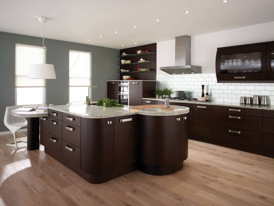 Contemporary kitchen with light granite counters dark wood island