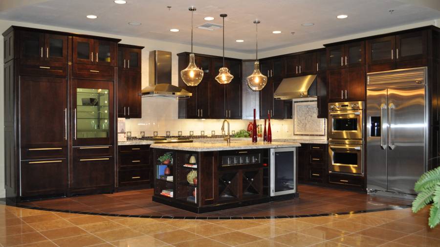 Contemporary kitchen with light granite counters dark wood island