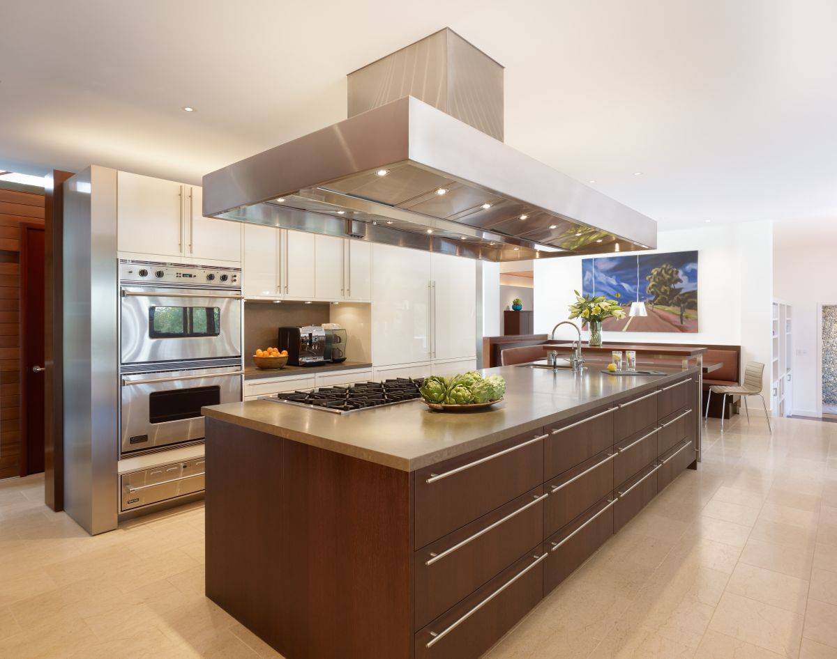 contemporary kitchen with limestone and rich wood cabinetry