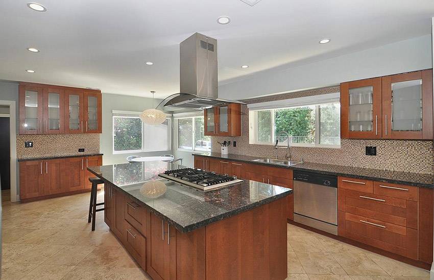 contemporary kitchen with limestone and rich wood cabinetry