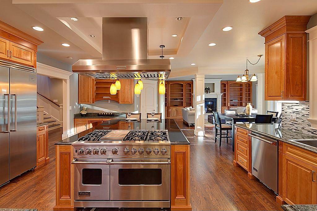 contemporary kitchen with limestone and rich wood cabinetry