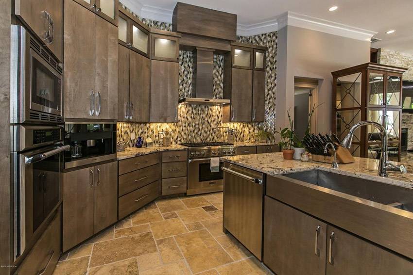 contemporary kitchen with limestone and rich wood cabinetry