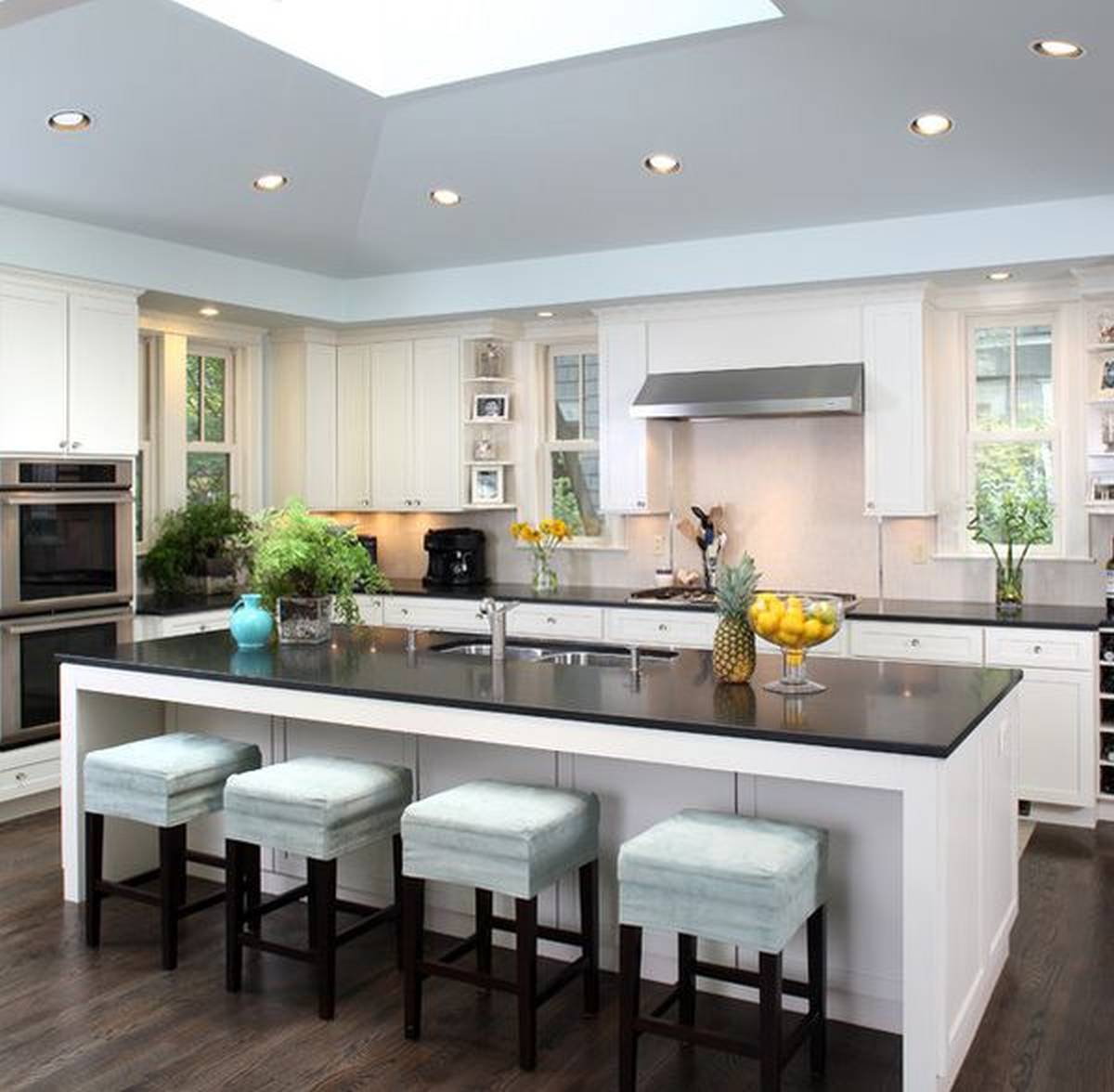 contemporary kitchen with limestone and rich wood cabinetry