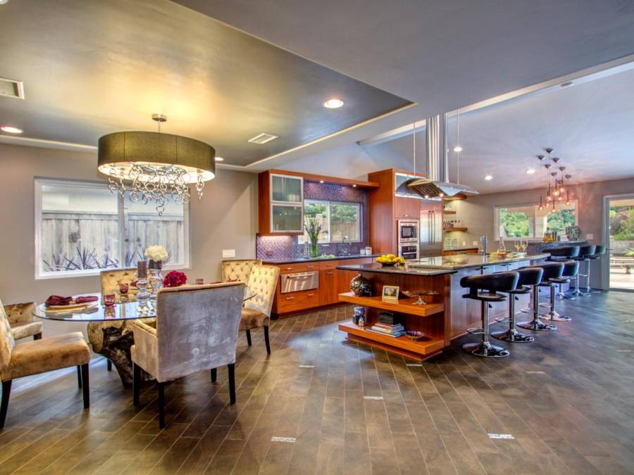 Contemporary kitchen with hardwood floors open to dining room