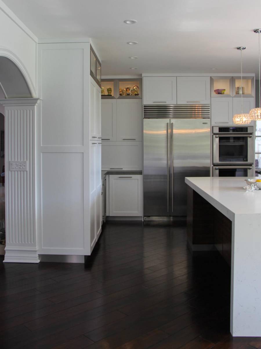 Contemporary kitchen with hardwood floors open to dining room