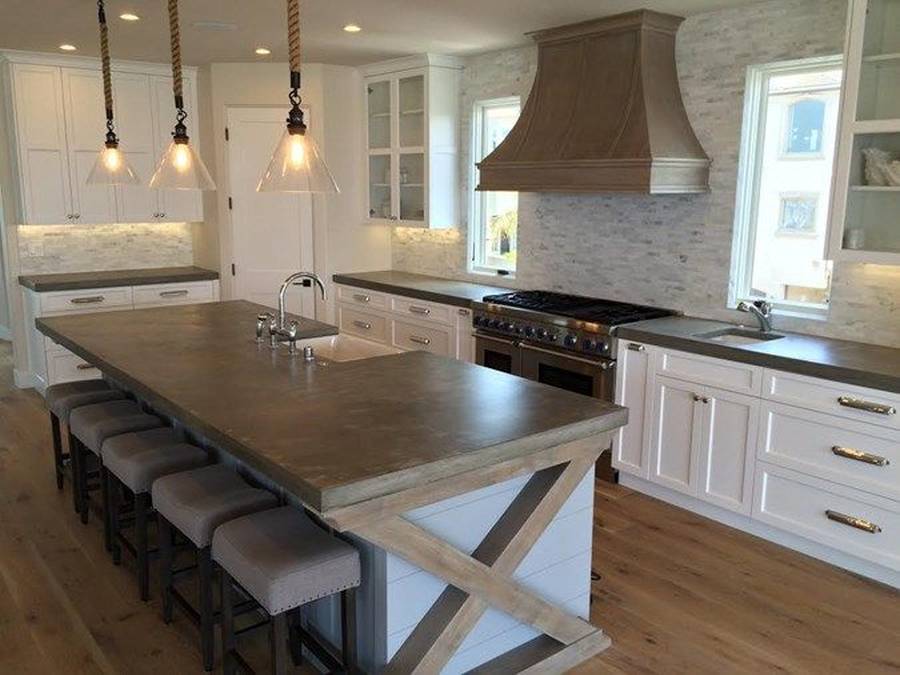 Designer custom kitchen with concrete counter island with dining nook