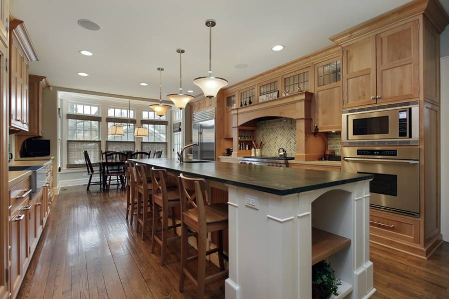 Designer custom kitchen with concrete counter island with dining nook