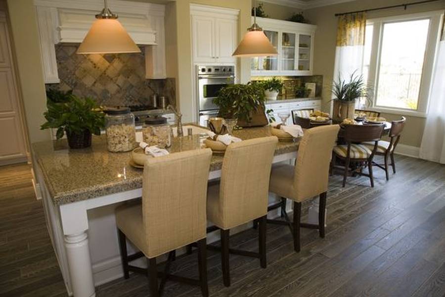 Designer custom kitchen with concrete counter island with dining nook