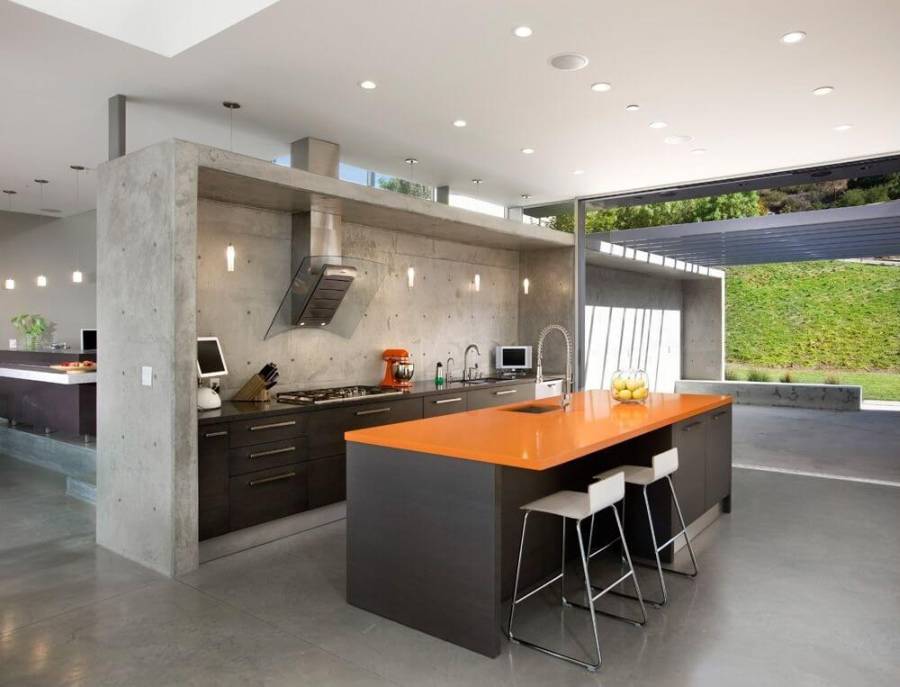 Designer custom kitchen with concrete counter island with dining nook