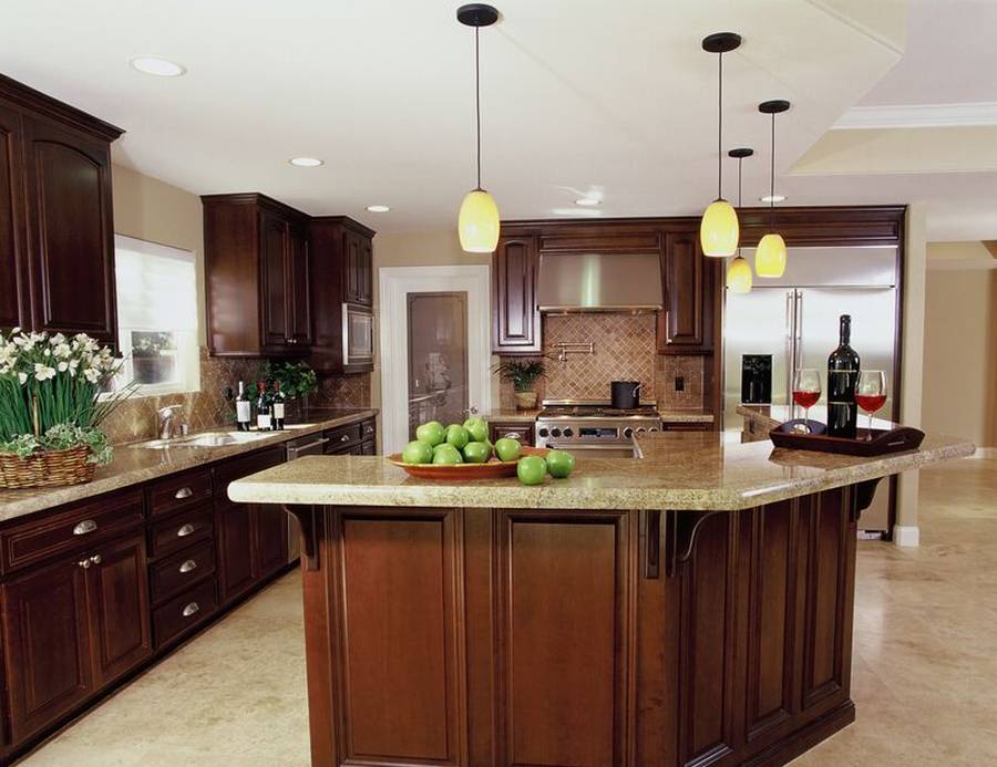 Kitchen with beige granite counters travertine tile floor and rich wood cabinets