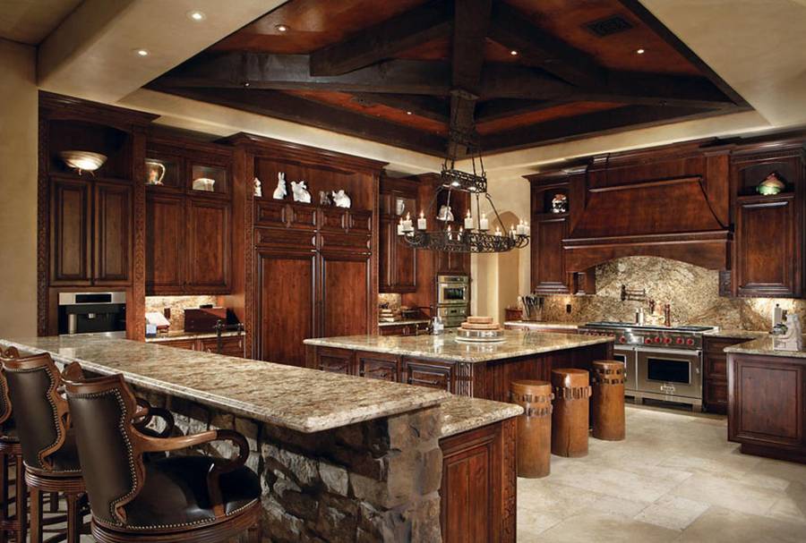 Kitchen with beige granite counters travertine tile floor and rich wood cabinets