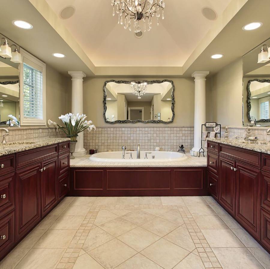 Kitchen with beige granite counters travertine tile floor and rich wood cabinets