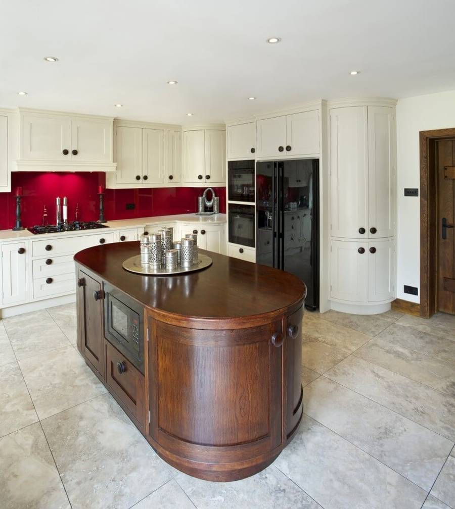 Kitchen with beige granite counters travertine tile floor and rich wood cabinets