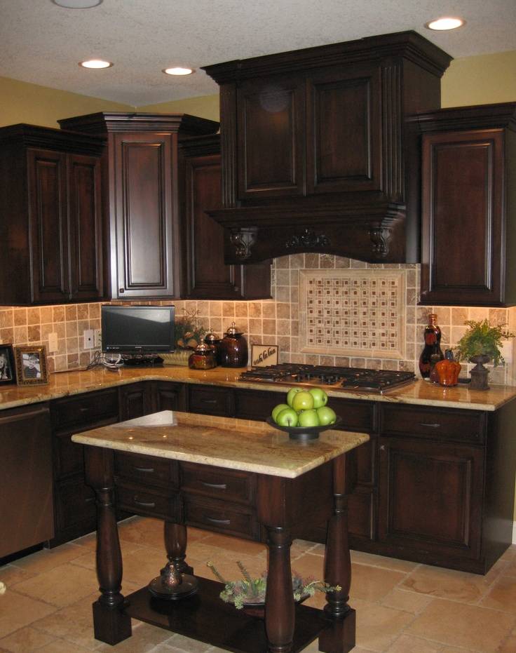Kitchen with beige granite counters travertine tile floor and rich wood cabinets