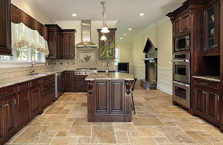 Kitchen with beige granite counters travertine tile floor and rich wood cabinets