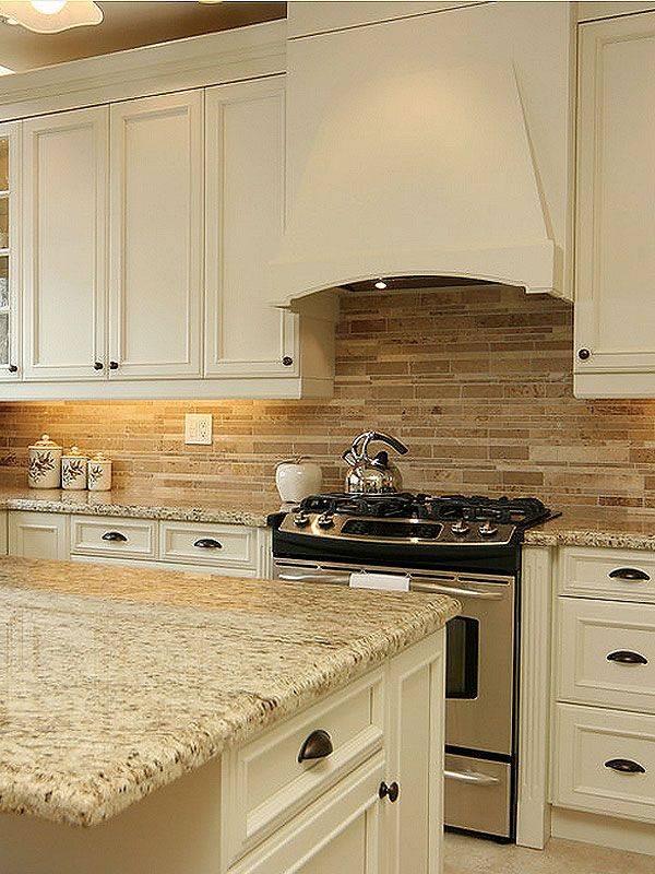 Kitchen with beige granite counters travertine tile floor and rich wood cabinets