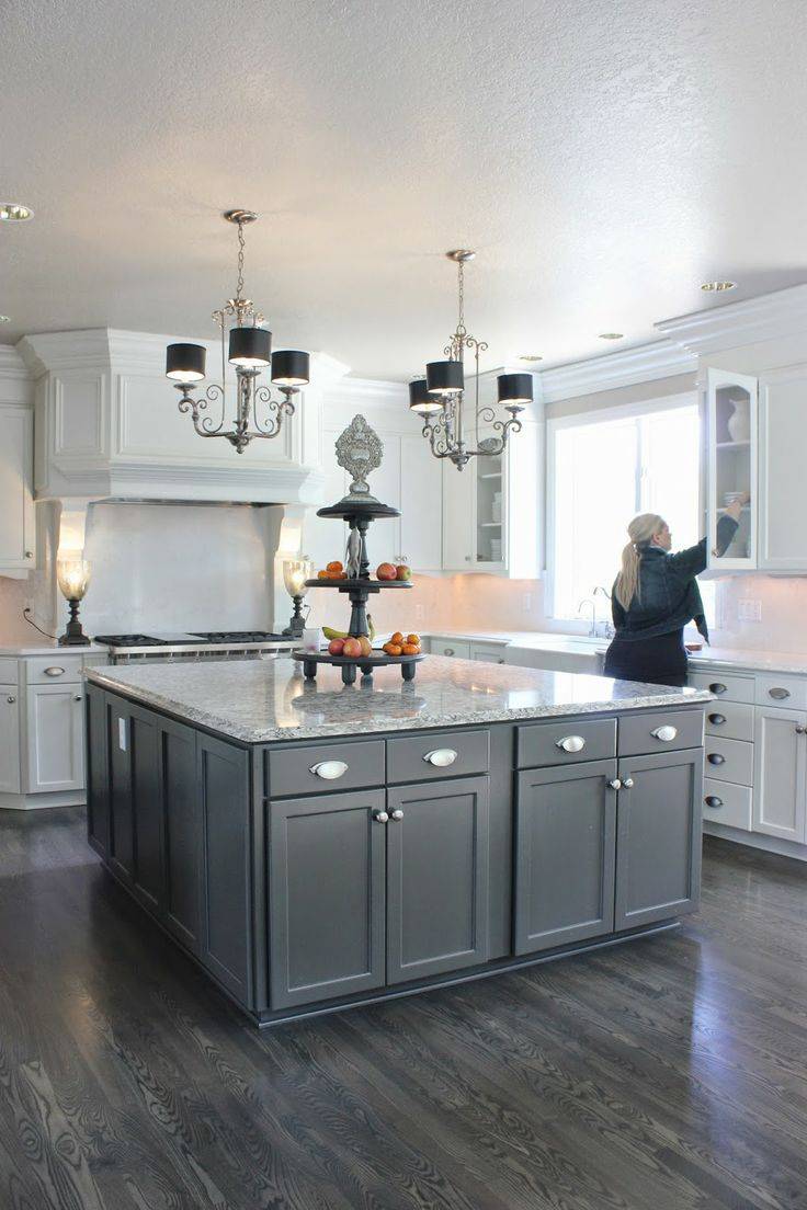 Kitchen with open layout, limestone flooring and dark cabinetry