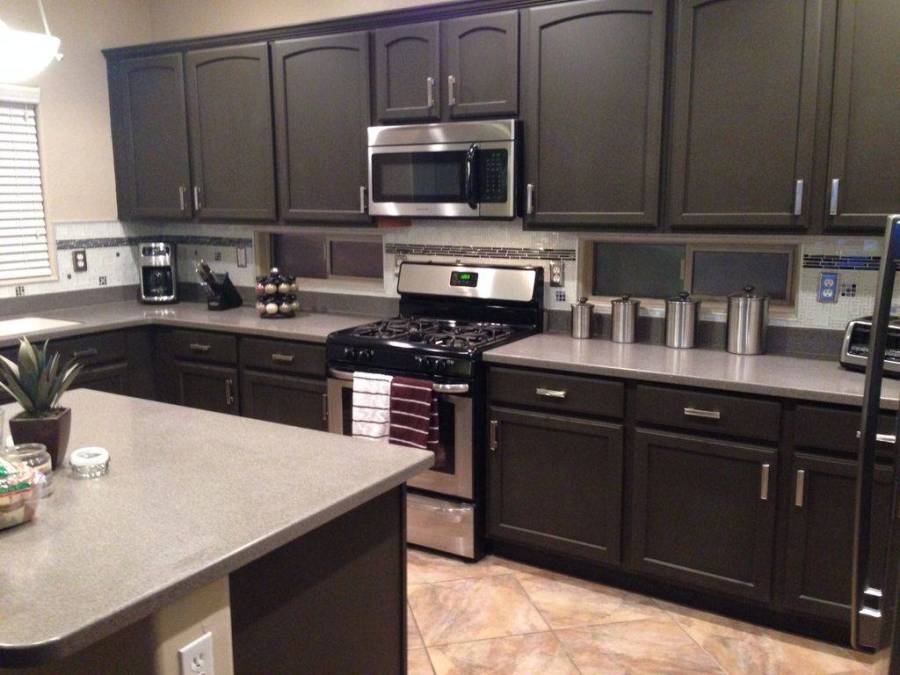 Kitchen with open layout, limestone flooring and dark cabinetry